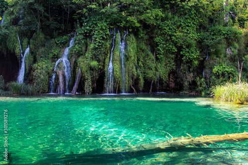 Plitvice Lakes National Park. Croatia’s most popular tourist attraction. Small rivers, waterfalls and lakes in the forest. Natural beauty mountainous region. Pedestrian routes. Summer. Europe.