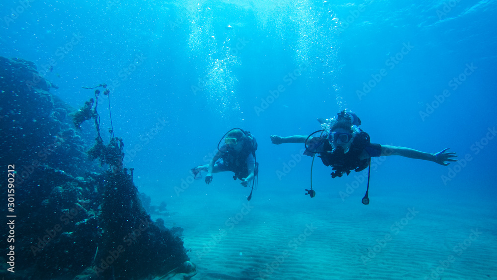 Diving with air balloon in the red sea. Instructor. Girl and coral reefs. Traveling lifestyle. Water sports. Beach holidays. Diving with air balloon in the red sea. Instructor. Girl and coral reefs. Traveling lifestyle. Water sports. Beach holidays.