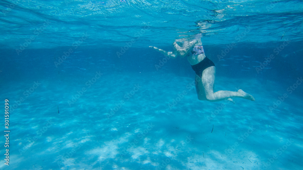 Diving in the red sea. Sexy girl in bikini and mask. Snorkeling. Traveling lifestyle. Water sports. Beach holidays.