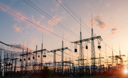 The silhouette of the evening electricity transmission pylon. Power transmission from a power plant to a city. photo