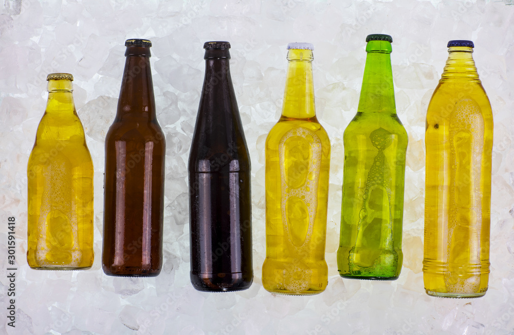 Beer bottles with cold ice cubes Beer bottles with cold ice cubes