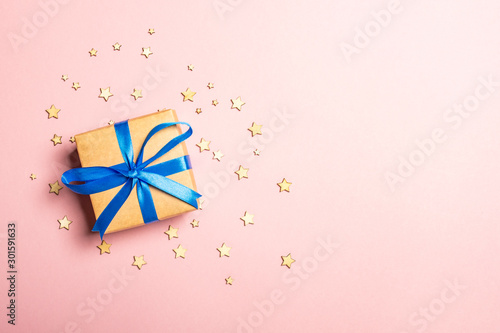 Gift box on a pink background with stars. Gift concept for a loved one, holiday, Christmas. Flat lay, top view