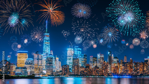 New Years Eve with colorful Fireworks over New York City skyline long exposure with beautiful dark blue sky, sci-fi orange city light glow and reflections in the river © Atmosphere