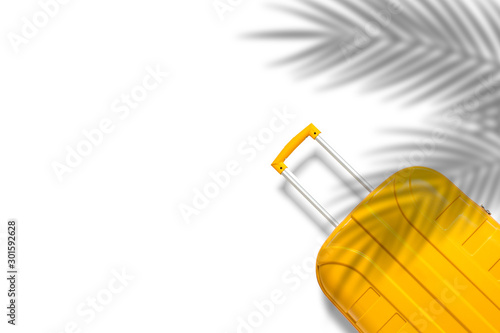 Yellow suitcase under the shadow of palm leaves on a white background. Travel and vacation concept in triples. Flat lay, top view