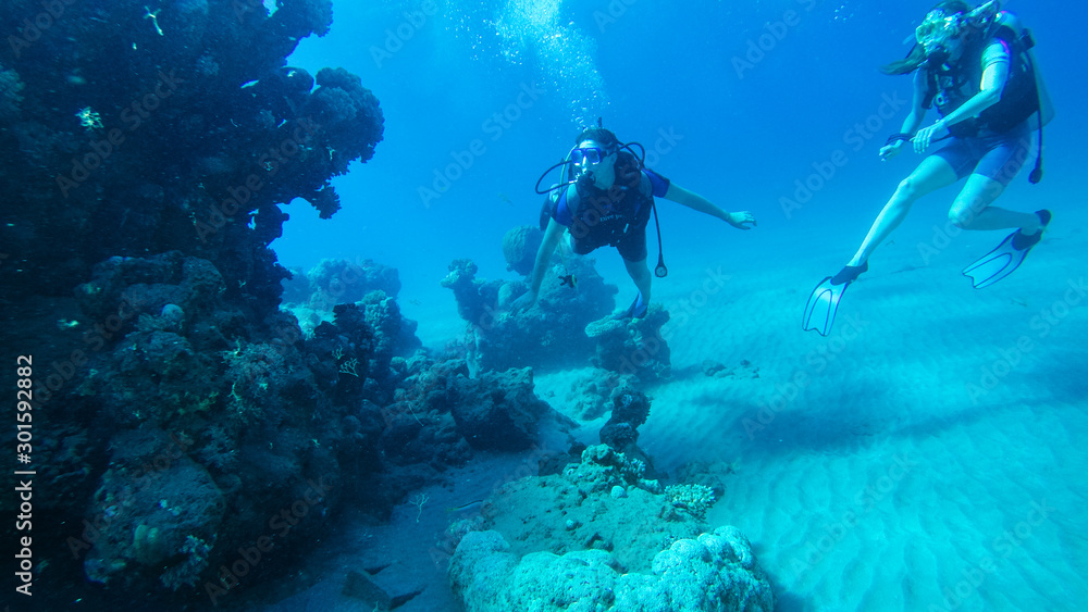 Diving with air balloon in the red sea. Instructor. Girl and coral reefs. Traveling lifestyle. Water sports. Beach holidays.