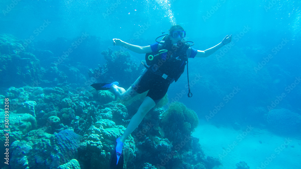 Diving with air balloon in the red sea. Instructor. Girl and coral reefs. Traveling lifestyle. Water sports. Beach holidays. Diving with air balloon in the red sea. Instructor. Girl and coral reefs. Traveling lifestyle. Water sports. Beach holidays.