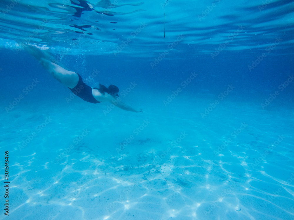 Naklejka premium Diving in the red sea. Sexy girl in bikini and mask. Snorkeling. Traveling lifestyle. Water sports. Beach holidays.
