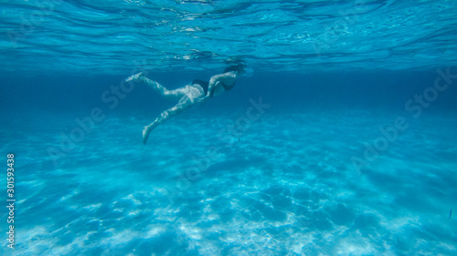 Diving in the red sea. Sexy girl in bikini and mask. Snorkeling. Traveling lifestyle. Water sports. Beach holidays. © Yaroslav