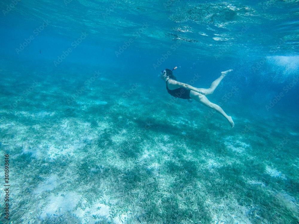 Diving in the red sea. Sexy girl in bikini and mask. Snorkeling. Traveling lifestyle. Water sports. Beach holidays.