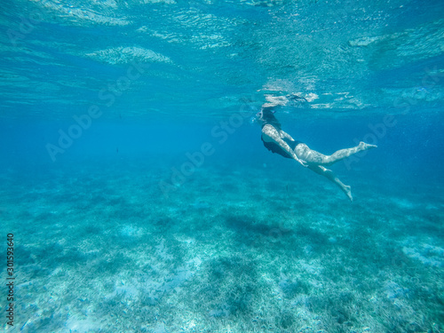 Diving in the red sea. Sexy girl in bikini and mask. Snorkeling. Traveling lifestyle. Water sports. Beach holidays. © Yaroslav