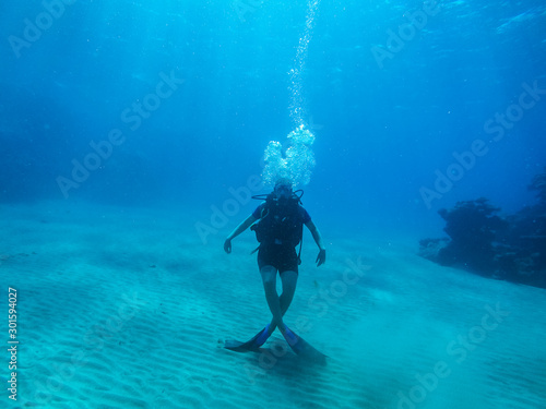 Diving with air balloon in the red sea. Instructor. Girl and coral reefs. Traveling lifestyle. Water sports.Yoga underwater