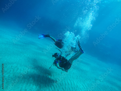 Diving with air balloon in the red sea. Instructor. Girl and coral reefs. Traveling lifestyle. Water sports.Yoga underwater © Yaroslav