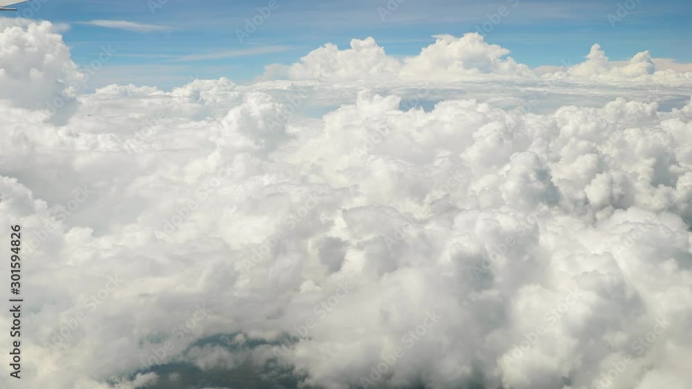 Flying between clouds, view from plane window during flight Flying between clouds, view from plane window during flight