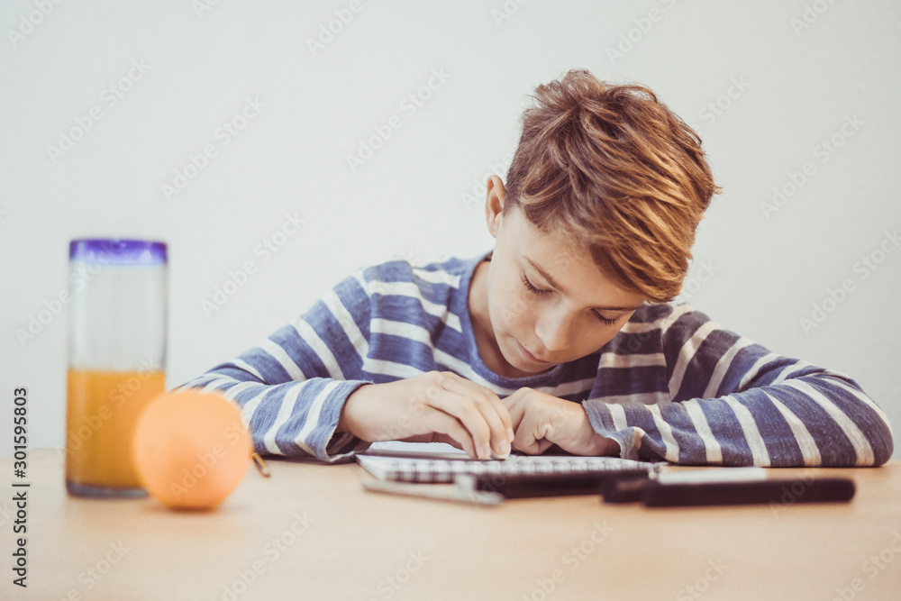 Student drawing with pencil on the notebook. Boy doing homework writing on a paper. Kid hold a pencil and draw a manga at home. Teen drawing sitting at the table. Education art talent ability concept. Student drawing with pencil on the notebook. Boy doing homework writing on a paper. Kid hold a pencil and draw a manga at home. Teen drawing sitting at the table. Education art talent ability concept.
