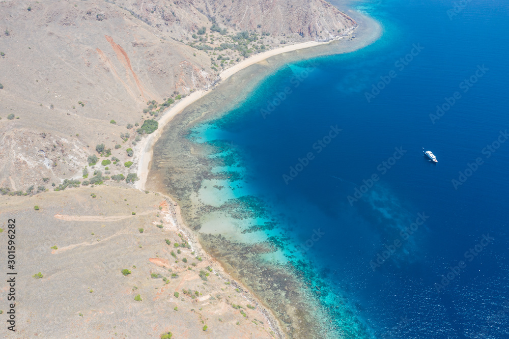 A beautiful fringing reef grows along the coastline of Komodo Island in Komodo National Park, Indonesia. This area is known for both its dragons as well as its incredible marine biodiversity.