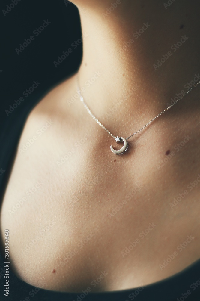 Tender jewerly on female neck, close up shot