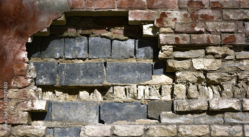 Destroyed brick wall in gru...