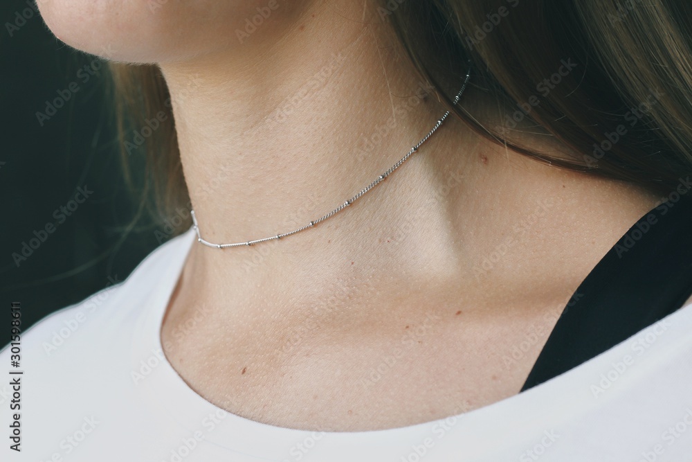 Tender jewerly on female neck, close up shot