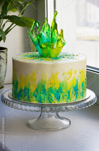 bright holiday cake with caramel decoration on the windowsill