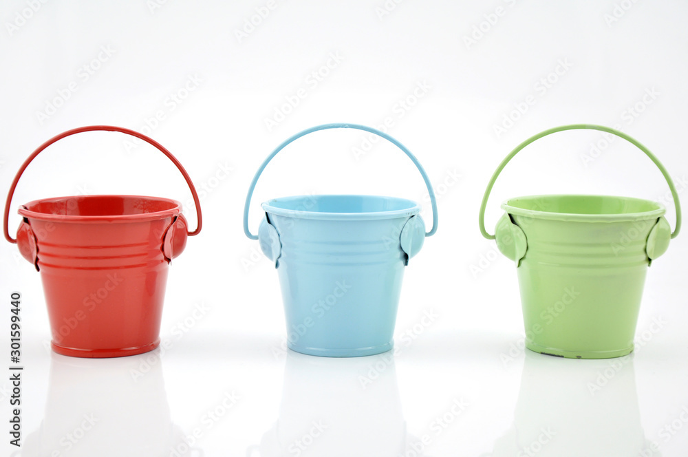 Three metal buckets of different colours with handle Three metal buckets of different colours with handle