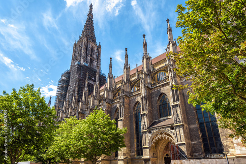 Ulm Minster or Cathedral of Ulm city, Germany. It is famous landmark of Ulm. Panorama of ornate facade of Gothic church in summer. Scenery of medieval European architecture on sunny day.