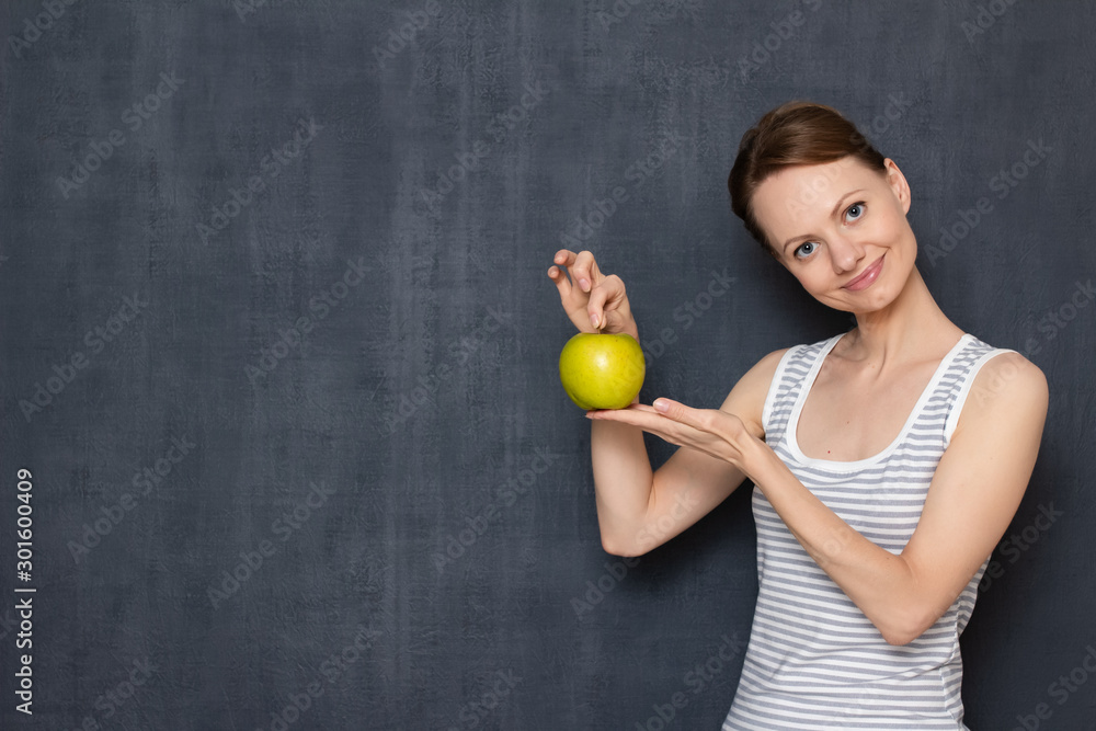 Portrait of happy young woman holding ripe apple in hands Portrait of happy young woman holding ripe apple in hands