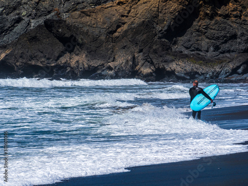 California Surfer and his turquoise Board enjoy the sea