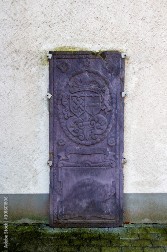 Old tombstone, Church of St. Wendelin of Trier bell tower in Wallerode, Belgium photo