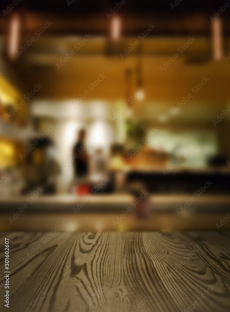 Blurred coffee shop background to promote your own coffee product. Just place your product in the middle of the frame, on the wooden bar for a pack shot Blurred coffee shop background to promote your own coffee product. Just place your product in the middle of the frame, on the wooden bar for a pack shot