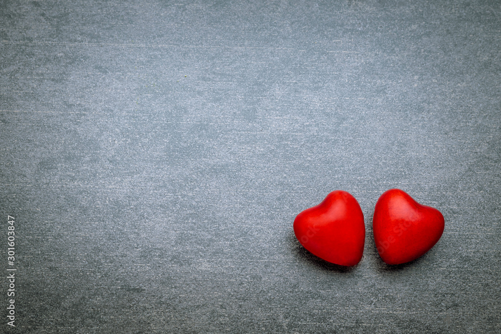 Obraz premium Two lovers hearts on gray background with copy space. Valentines day concept.