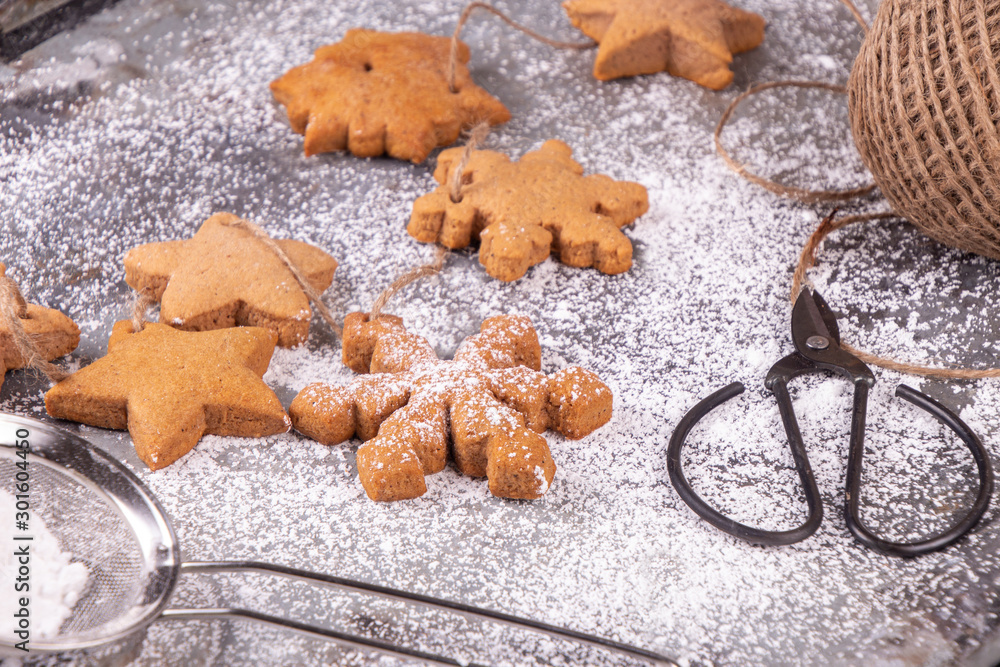 Christmas New Year traditional gingerbread cookies star and snowflake shape on rusty surfase with sugar powder. T
