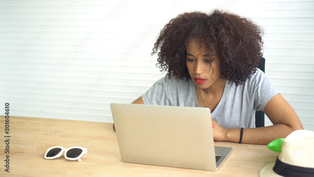 African woman working with laptop from home serious entrepreneur mindset African woman working with laptop from home serious entrepreneur mindset