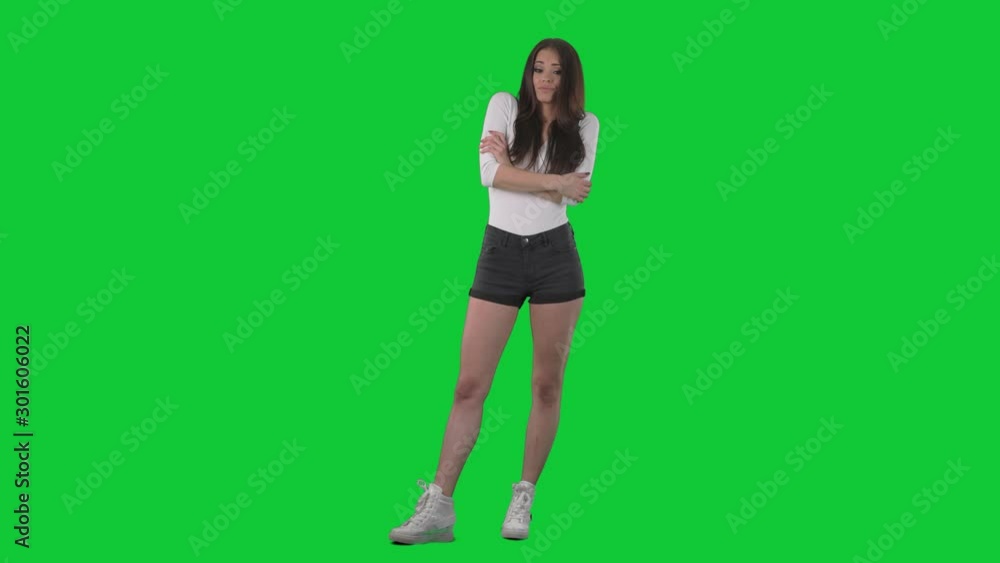 Annoyed disinterested woman with crossed arms rolling eyes and shake head with refusal. Full body over green screen background. Annoyed disinterested woman with crossed arms rolling eyes and shake head with refusal. Full body over green screen background.