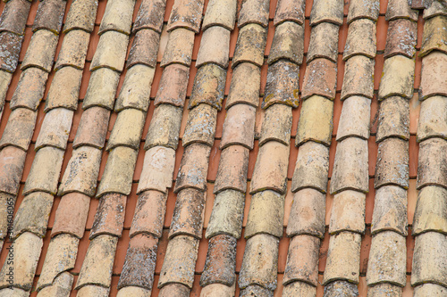 Fragment of a tiled roof. Clay tiles. Background. Pattern. Terracotta. Gray. Ocher. © DOF