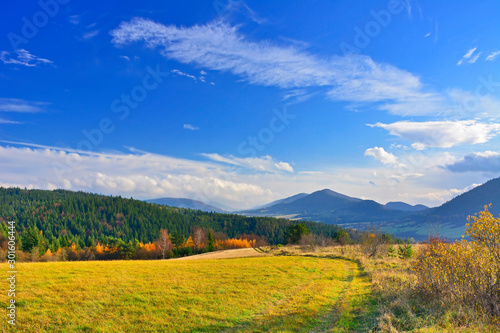 Dirt road and autumn mountains landscape in sunny day  Low Beskids  Beskid Niski .