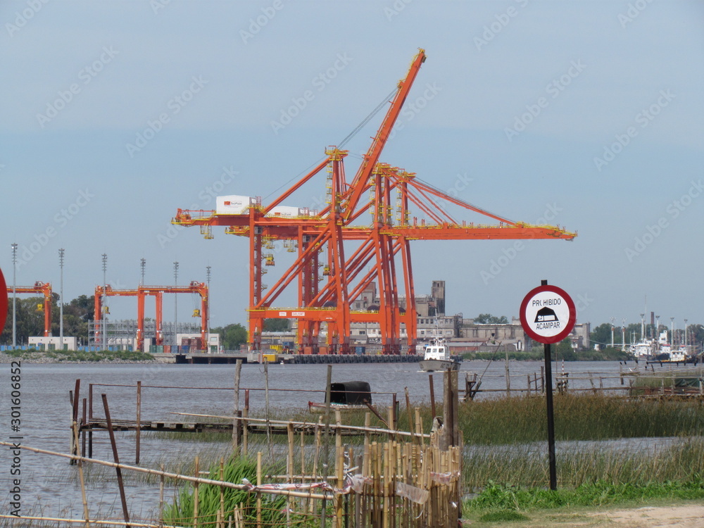 Fototapeta premium Translation: It is forbidden to camp. Container loading and unloading cranes.