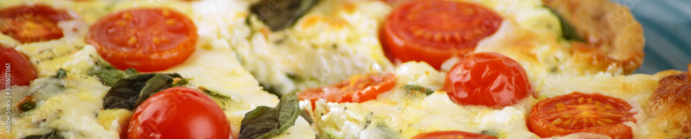 Quiche pie with spinach, cherry and mozzarella. Banner for the site. Close-up. The concept of delicious food, recipes. Quiche pie with spinach, cherry and mozzarella. Banner for the site. Close-up. The concept of delicious food, recipes.