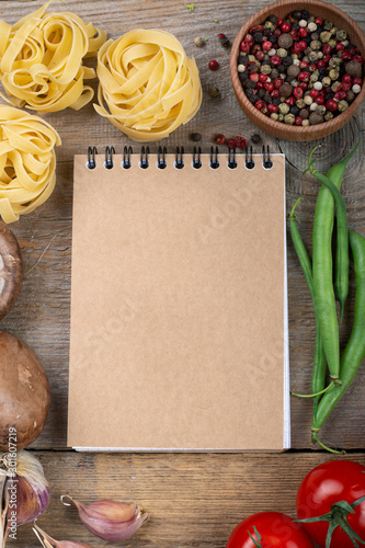 notebook for recipe and vegetables