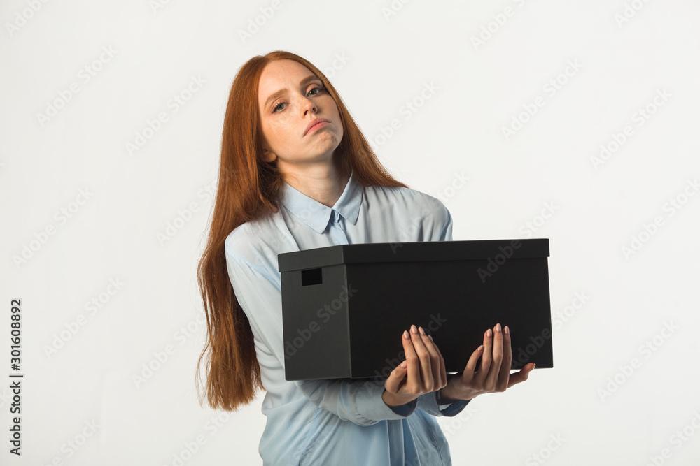 beautiful young woman with red hair with a box in her hands beautiful young woman with red hair with a box in her hands