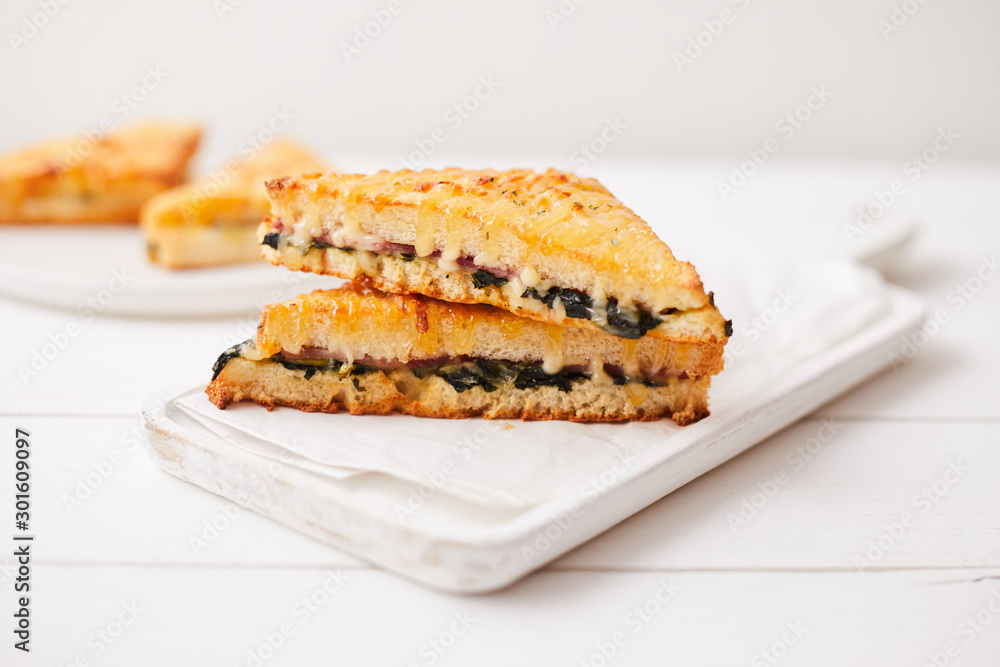 Baked spinach and ham sandwich with sauce. Baked spinach and ham sandwich with sauce.
