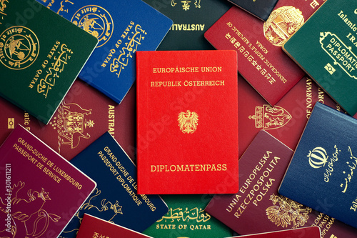 Austrian diplomatic passport on the background of multi-colored passports of the world photo
