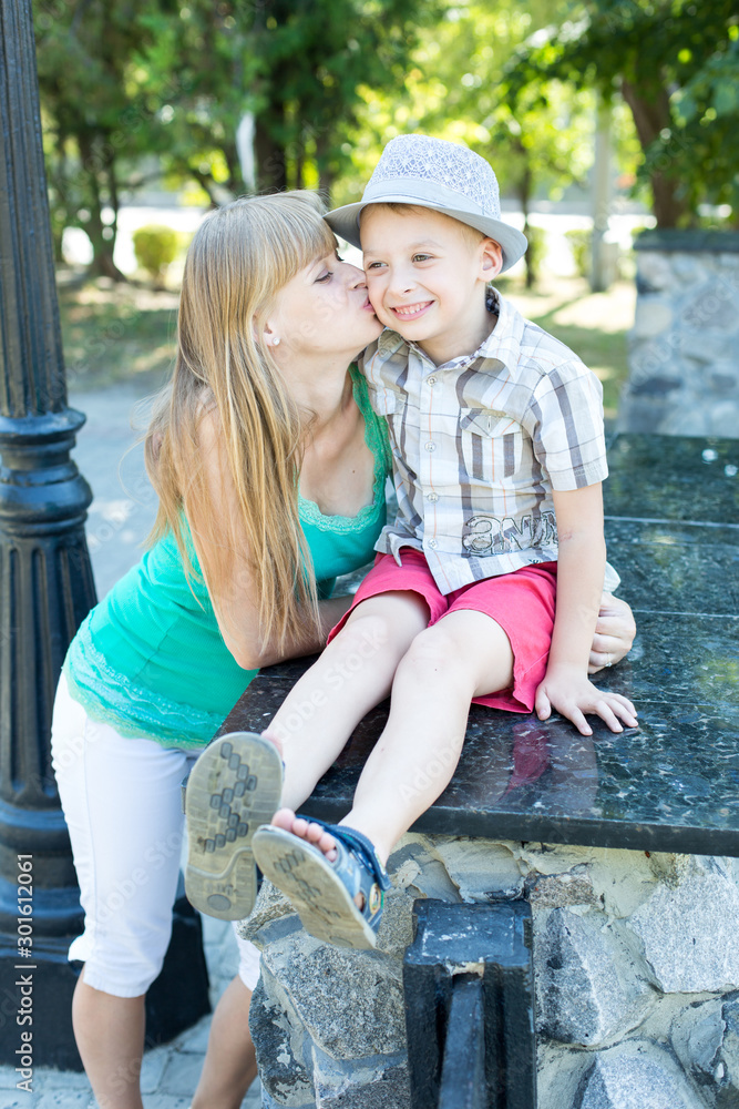 portrait of a mother with her son on a walk. the boy in the hat portrait of a mother with her son on a walk. the boy in the hat