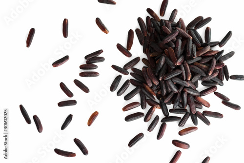 A bunch of unpolished black rice grains isolated on white background.