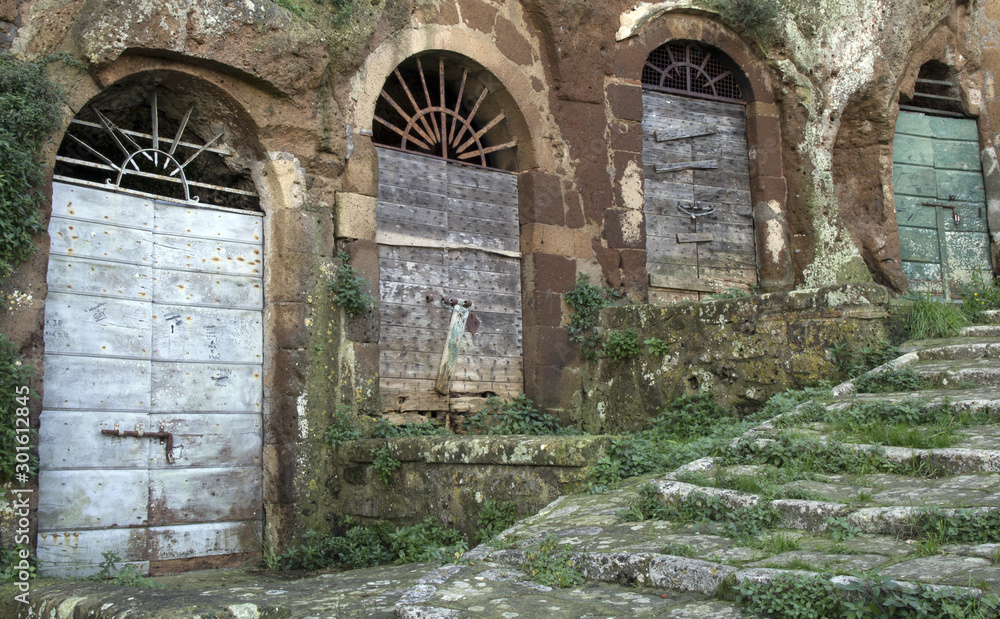 Pitigliano, one of the best town in Tuscany, Italy. Cellar doors in the medieval district.