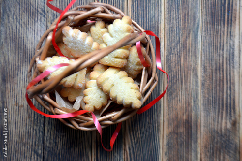 Christmas cookies in a basket on a wooden background
