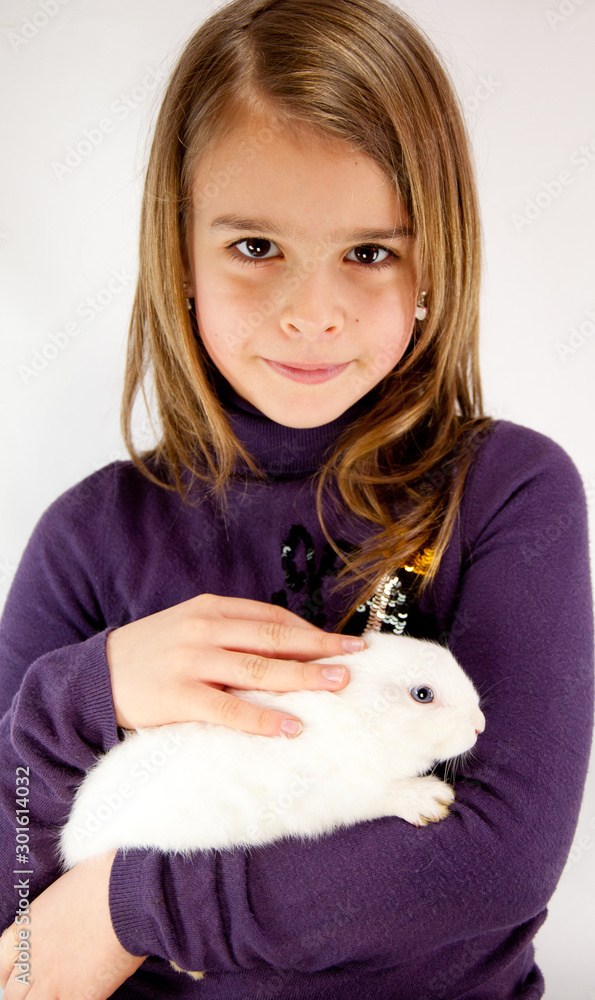 Little Girl 7Y Holding a White Bunny. White Background. Little Girl 7Y Holding a White Bunny. White Background.