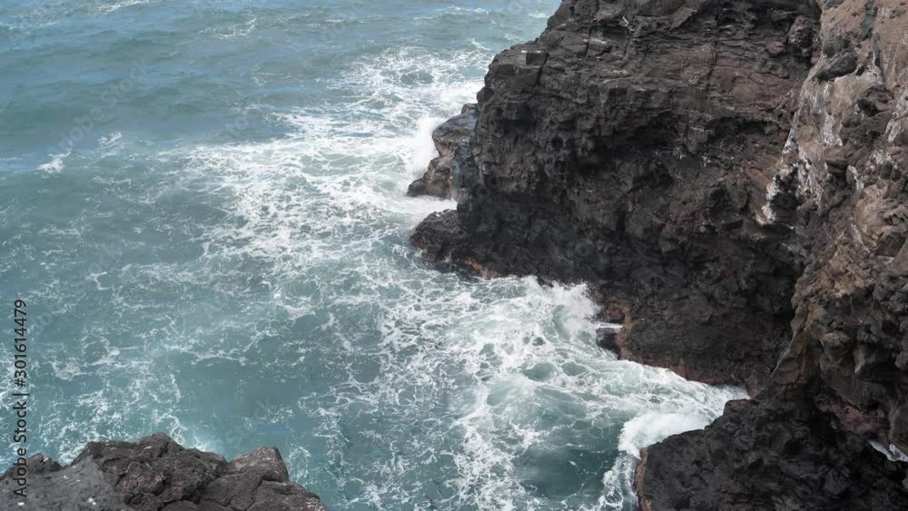 Breaking waves and dangerous rocks in Puerto de la Cruz city, Tenerife, Canary islands, Spain Breaking waves and dangerous rocks in Puerto de la Cruz city, Tenerife, Canary islands, Spain