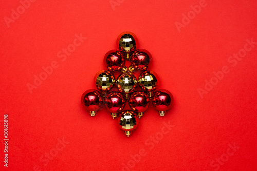 Red and gold Christmas decoration balls on red background. Winter season minimal composition