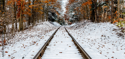 snow covered railroad tracks in late autumn 