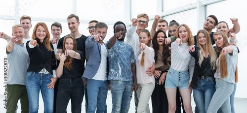 group of happy young men pointing at you.